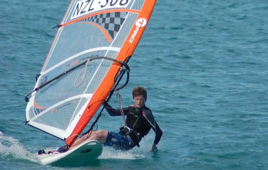 14 year old Murray’s Bay sailor Patrick Haybittle hanging 5 on the way back in after training. © Brian Haybittle